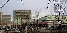 Olympia shopping mall from afar, street view, on partly cloudy winter day