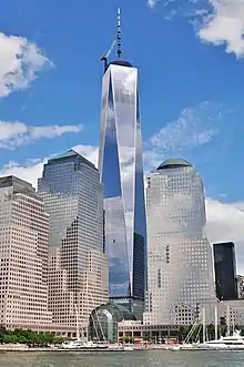 View of the 104 story One World Trade Centre with glass exteriors and a fantastic spire to match.