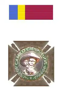 Photograph of a medal with Camilo Cienfuegos' face on it