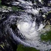 A mature cyclone over the eastern Indian Ocean near Australia. The storm is matured with a large area of deep thunderstorms and a well-defined eye. Western Australia can be seen in the bottom right of the image and some of the Indonesian islands can be seen at the top.