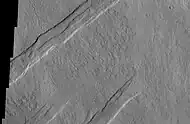 Oti Fossae, as seen by THEMIS.  These parallel graben are found on the northeastern side of Arsia Mons; they are in line with the NE/SW trend of the three volcanoes in Tharsis.