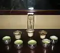 Votive candles on a Christian home altar surrounding a crucifix in crystal