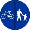 C-13/16 sign indicating compulsory track for pedestrians and bicycles – cyclists on left, pedestrians on right