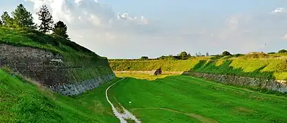 A stone wall set into the hillside surrounding Palmanova