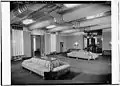 Basement lounge showing stylized couches and benches. Note the bold wall and ceiling designs