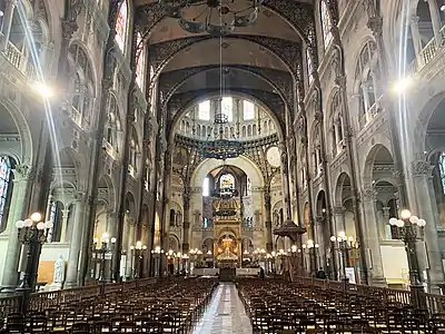 The nave, choir and the ciborium over the altar with the original high altar partially obstructed by the modern timber altar