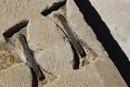 A so-called "swallow-tail" (or "dovetail") staple. This is an early, huge example of staple used in architecture in order to fasten stones together.