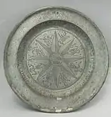 A plate made of pewter, an alloy of 85–99% tin and (usually) copper. Pewter was first used around the beginning of the Bronze Age in the Near East.