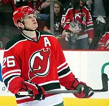 Patrick Elias during an ice hockey game with spectators in the background.