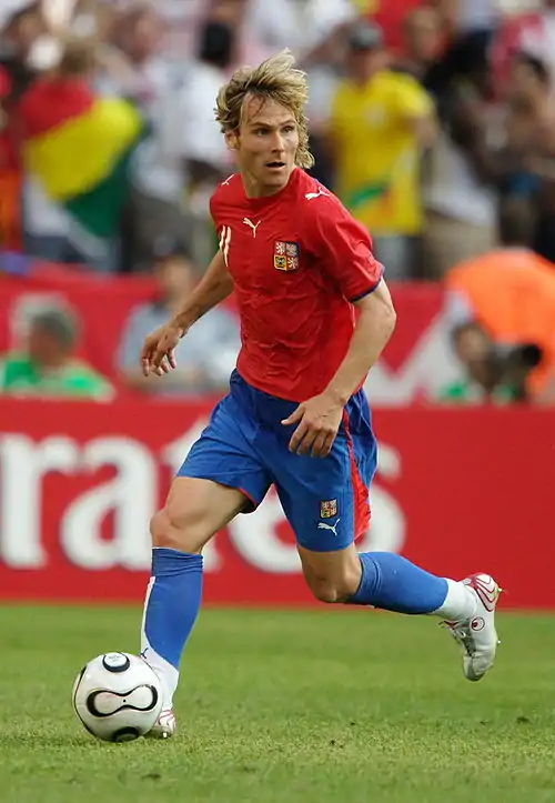 Nedvěd wearing the red shirt, blue shorts and blue socks of the Czech Republic