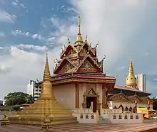 A pagoda and golden-coloured stupas at a Siamese temple.