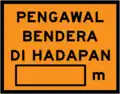 Flagman ahead with distance