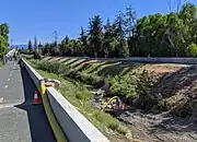 In July, 2019, the entire flow of the creek is diverted through a hose for creekbed weed cleanout by the Google campus.