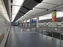 Underground station concourse, with lifts and escalators down to platform level