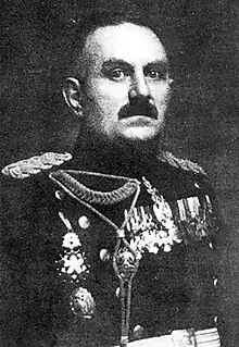 Black and white portrait of a dark-haired man wearing dress uniform with medals