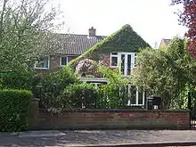 Larkin lived in a comfortable residential area in Hull at No.105, Newland Park in a detached house of red brick construction. Doors on the first floor at the front of the house open onto a small balcony. As seen in 2008 part of the walls at the front of the house are covered with a green climbing plant, but a round commemorative plaque is visible