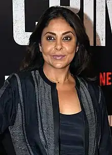 Shefali Shah smiling and looking at the camera.