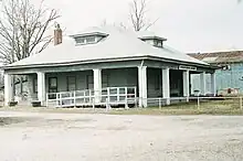 A large gray building currently serving as a museum.