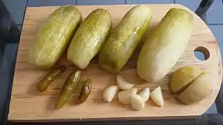 Fermented homemade pickled cucumber, chili pepper, garlic, and apple in the hot climate of Indonesia