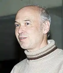  Pierre Deligne, seated, facing left and away from the camera