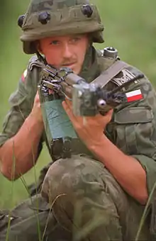 A Kbk AKMS fitted with a MILES laser training device in the hands of a Polish soldier in 1997.