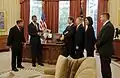 Lindsey, far left, presents a montage to Barack Obama as crew members Barratt, Boe, Stott and Bowen look on.