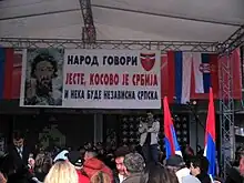 Group of people, flags and a cameraman