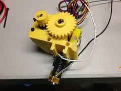 The original Prusa i3 MK0 extruder and hot end with yellow printed parts.