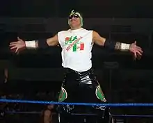 Wrestler Nicho el Millonario posing on the ring ropes prior to a match.