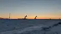 Silhouettes of pumpjacks at dusk on New Year's Day 2022