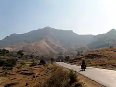 A road, with mountains in the background