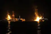 Q4000 and Discoverer Enterprise flare off gas at the site of drilling operations at the Deepwater Horizon response site in the Gulf of Mexico at night 8 July 2010.