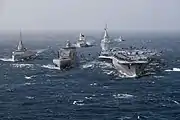 The French Navy as planned for the late 2030s: a Bâtiment ravitailleur de forces (fleet tanker) conducts simultaneous underway replenishment with the Future French aircraft carrier and with a Frégate de défense et d'intervention (Defence and Intervention Frigate).