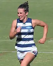 Female athlete in guernsey and shorts