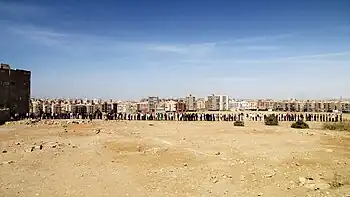 Very long line of men outside a building