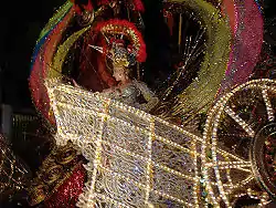 Queen of the carnival, surrounded by bright, colored lights