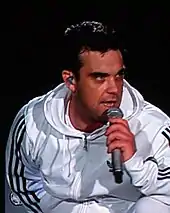 Colour photograph of Robbie Williams performing live in 2006