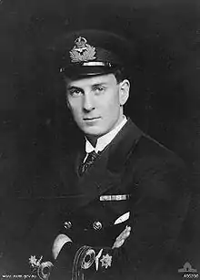 Half portrait of man in dark-coloured military uniform with peaked cap