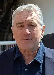 A 72-year-old man looking at the camera.