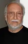 A bearded man is wearing a black shirt