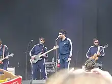 Eels onstage, wearing track suits