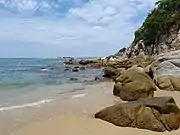 Rocks fringe the southern end of Arrocito Beach