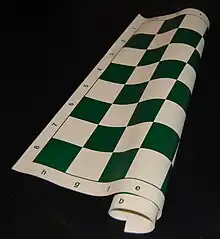 A portable green and buff vinyl rollup board