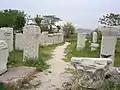 Column capitals and Roman tomb inscriptions scattered around the Roman Bath in Ankara.