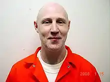 Mugshot of Gardner wearing an orange jumpsuit