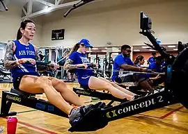 Several indoor rowers