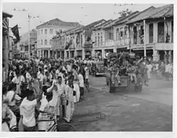 Civilians lining the city's streets to welcome British troops arriving on jeeps in 1945.