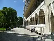 One of the arcaded galleries on the mosque's exterior and the water taps for ablutions