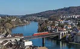 An SBB Red Arrow double railcar crossing the Feuerthalen Rhine bridge [de] between Feuerthalen (right) and Schaffhausen (left)