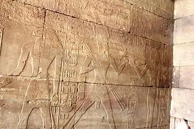 Temple of Kumma: The ram-headed Khnum (left) and Tuthmosis III (center) running towards Hathor (right) offering her a lapwing